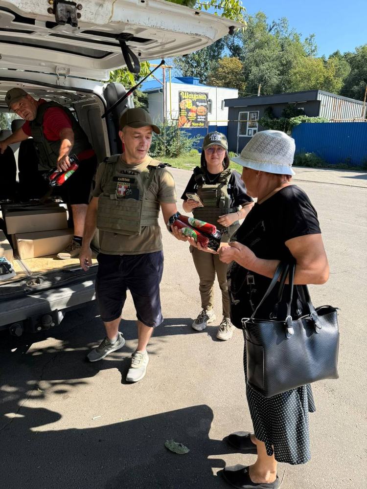 Volunteers unloading aid from a van